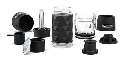 Hiker holding Dejess portable hand press espresso maker on mountain trail outdoor adventure