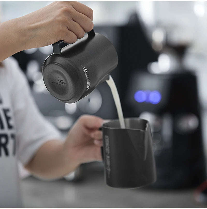 MHW-3BOMBER barista steam pitcher standing upright on espresso bar black background