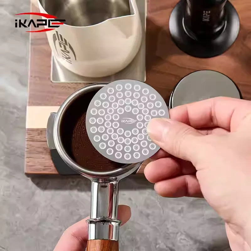 IKAPE V2 puck screen 58mm installed in portafilter showing even pre-infusion water contact