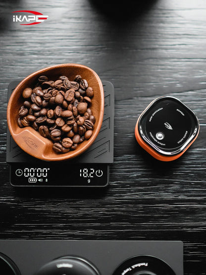 IKAPE 20ml RDT spray bottle next to portafilter and coffee beans on wooden surface